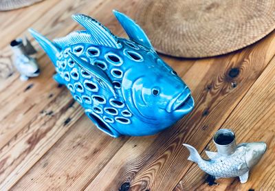 High angle view of fish figurines on wooden table