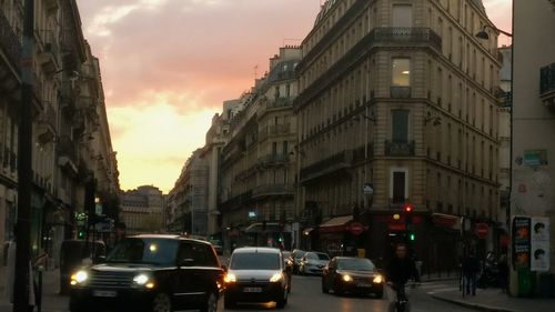 Traffic on road at sunset