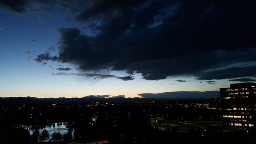 Illuminated cityscape against sky at dusk