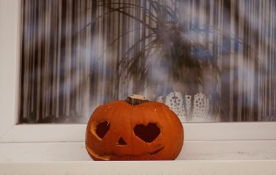 Close-up of halloween pumpkin on glass