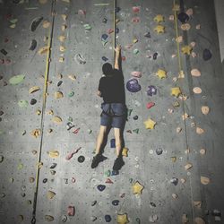 Full length rear view of man with umbrella