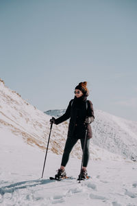 Man skiing on snow covered landscape