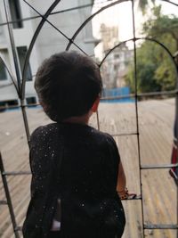 Rear view of girl standing outdoors