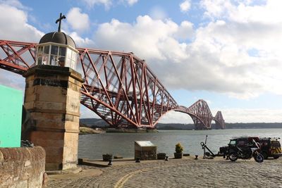 View of bridge over sea against cloudy sky