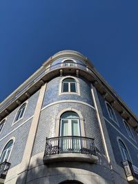Low angle view of building against clear blue sky