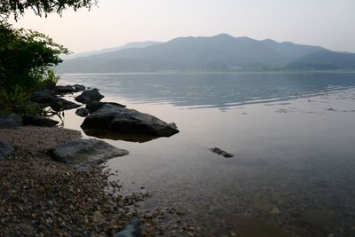 Scenic view of lake and mountains against sky