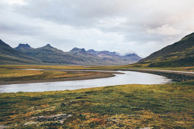 Scenic view of lake against cloudy sky