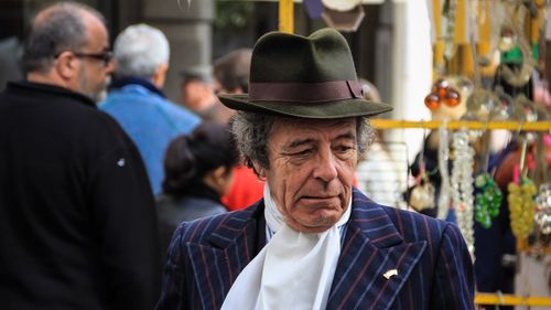 Portrait of man wearing hat in market