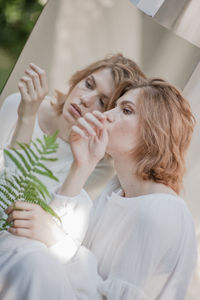 Portrait of a young woman looking away at home