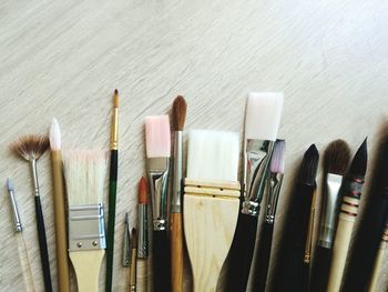 High angle view of brushes on wooden table