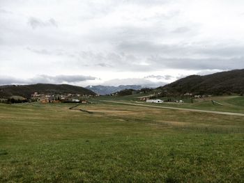 Scenic view of landscape against cloudy sky