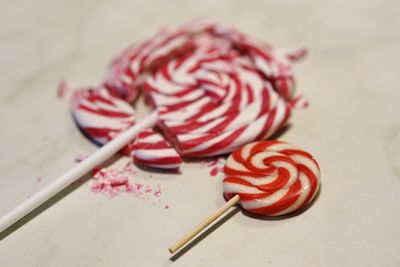 Close-up of lollipops on white table