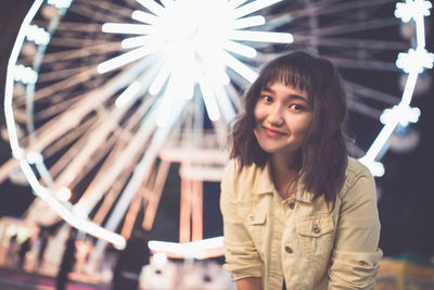 Beautiful asian girl in an amusement park, smiling. spring or summer time 