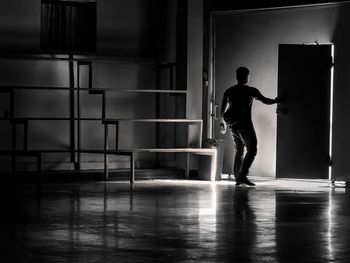 Rear view of man standing in corridor