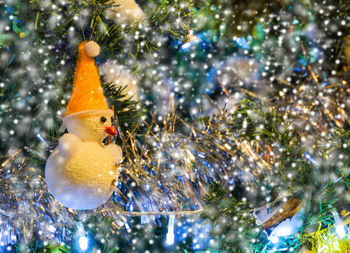 Close-up of christmas ornaments on tree