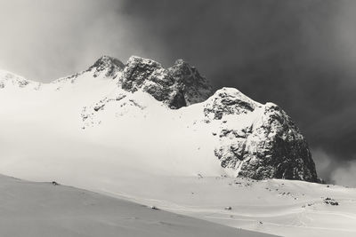 Scenic view of snow covered mountains against sky