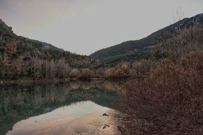 Scenic view of lake and mountains against clear sky