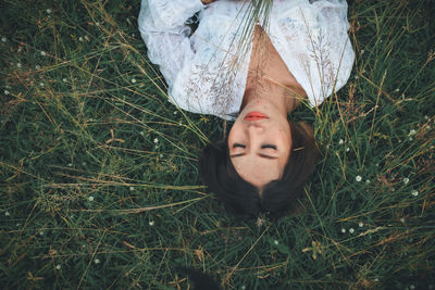 Portrait of woman lying on field