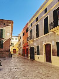 Alley amidst buildings against sky in city