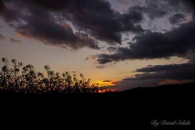 Scenic view of silhouette landscape against sky at sunset