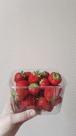 Close-up of hand holding strawberries