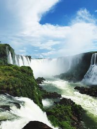 Scenic view of waterfall against sky