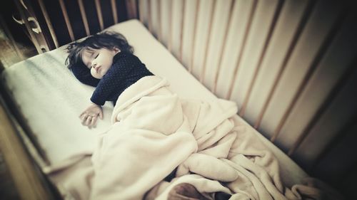 Portrait of child sleeping in bed