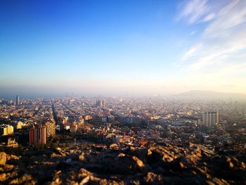 Aerial view of buildings in city against sky