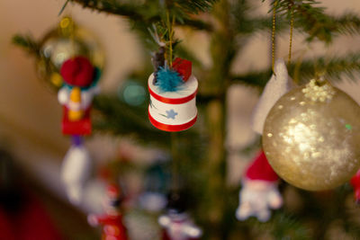 Close-up of christmas decorations hanging on tree