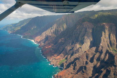 Aerial view of sea and mountains against sky