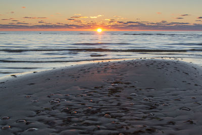 Scenic view of beach against sky during sunset