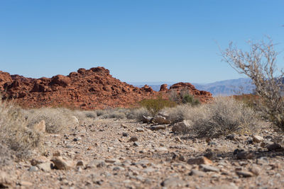 Scenic view of desert against clear blue sky