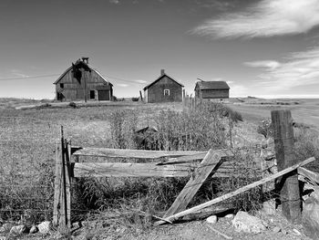 Old house on field against sky