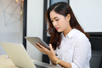 Young woman using laptop at home