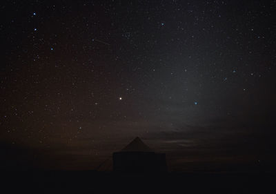 Low angle view of a tent against sky at night