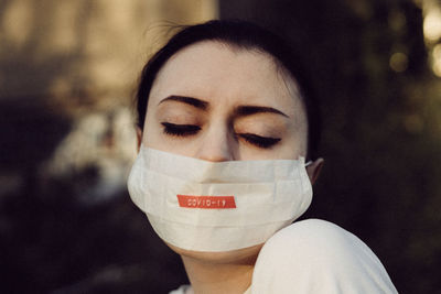 Close-up young woman wearing mask