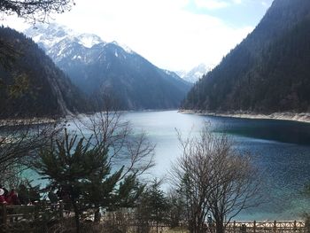 Scenic view of river and mountains against sky