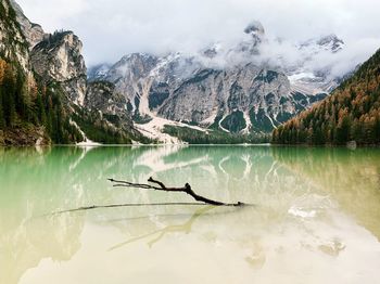 Scenic view of lake by mountains against sky