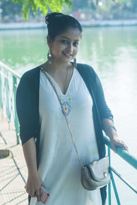 Portrait of a smiling young woman standing outdoors