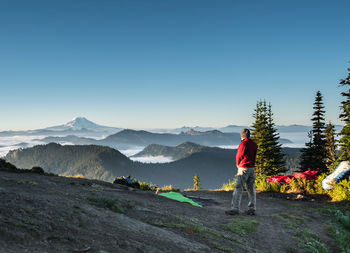 Man standing on mountain against clear sky