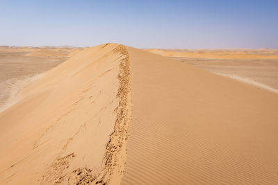 Scenic view of desert against clear sky