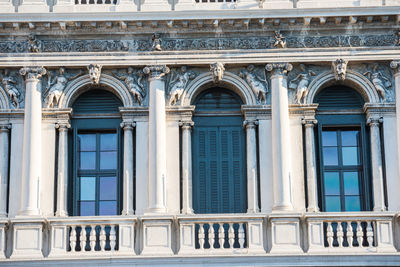Facade with windows, columns and decorations of old building at piazza san marco. venice, italy