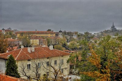 High angle view of houses in town against sky