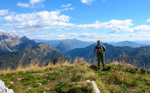 Man looking at mountains against sky