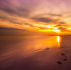 Scenic view of sea against orange sky