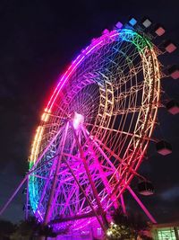 Illuminated ferris wheel at night