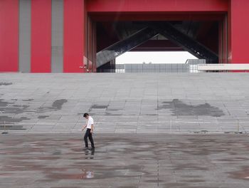 Side view of people walking in front of steps