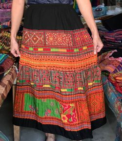 Low section of woman wearing skirt while standing in store