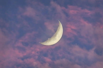 Low angle view of half moon against sky at night