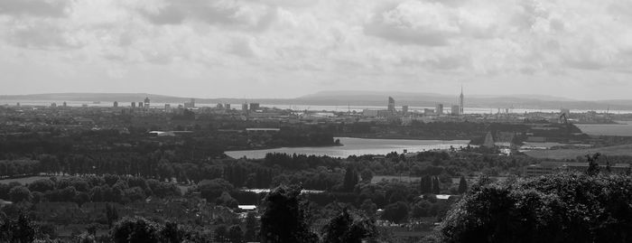 High angle shot of river with cityscape in background